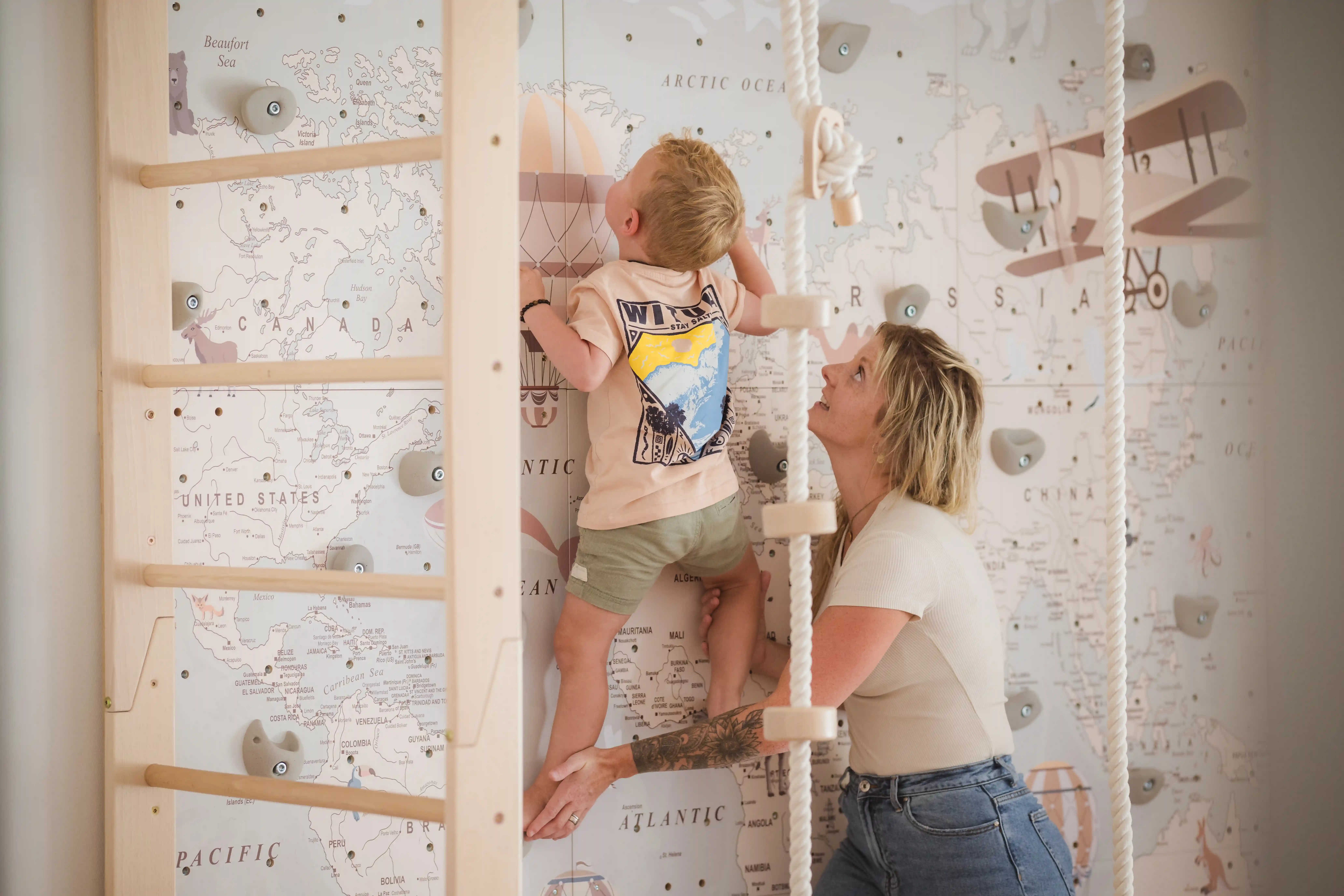 Photo de séance de physiothérapie pédiatrique - Enfant sur un mur de grimpe accompagné de Noémie Rondez, physiothérapeute